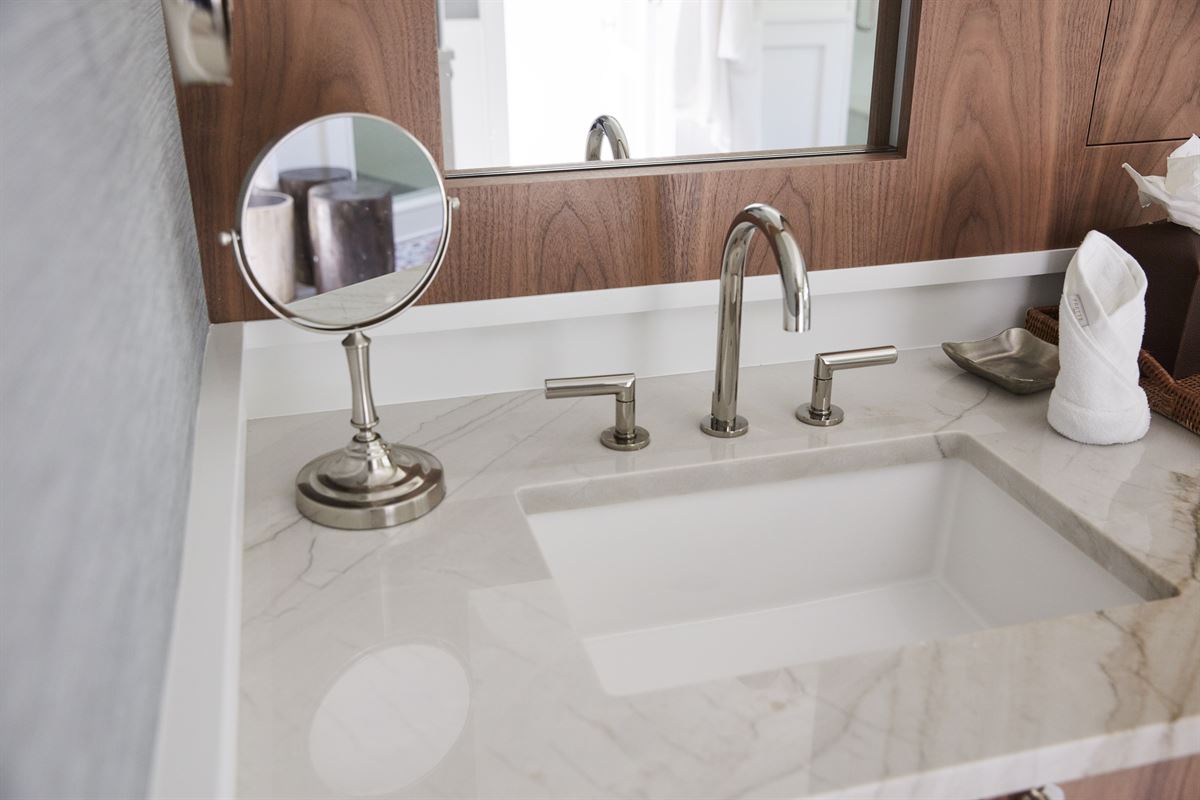 Marble vanity with brushed nickel widespread faucet