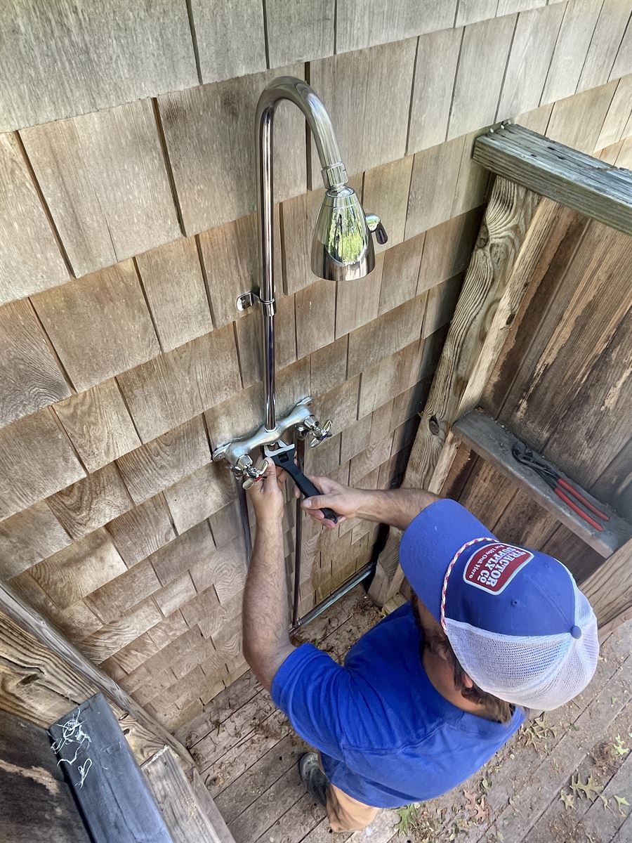 Technician servicing an outdoor shower