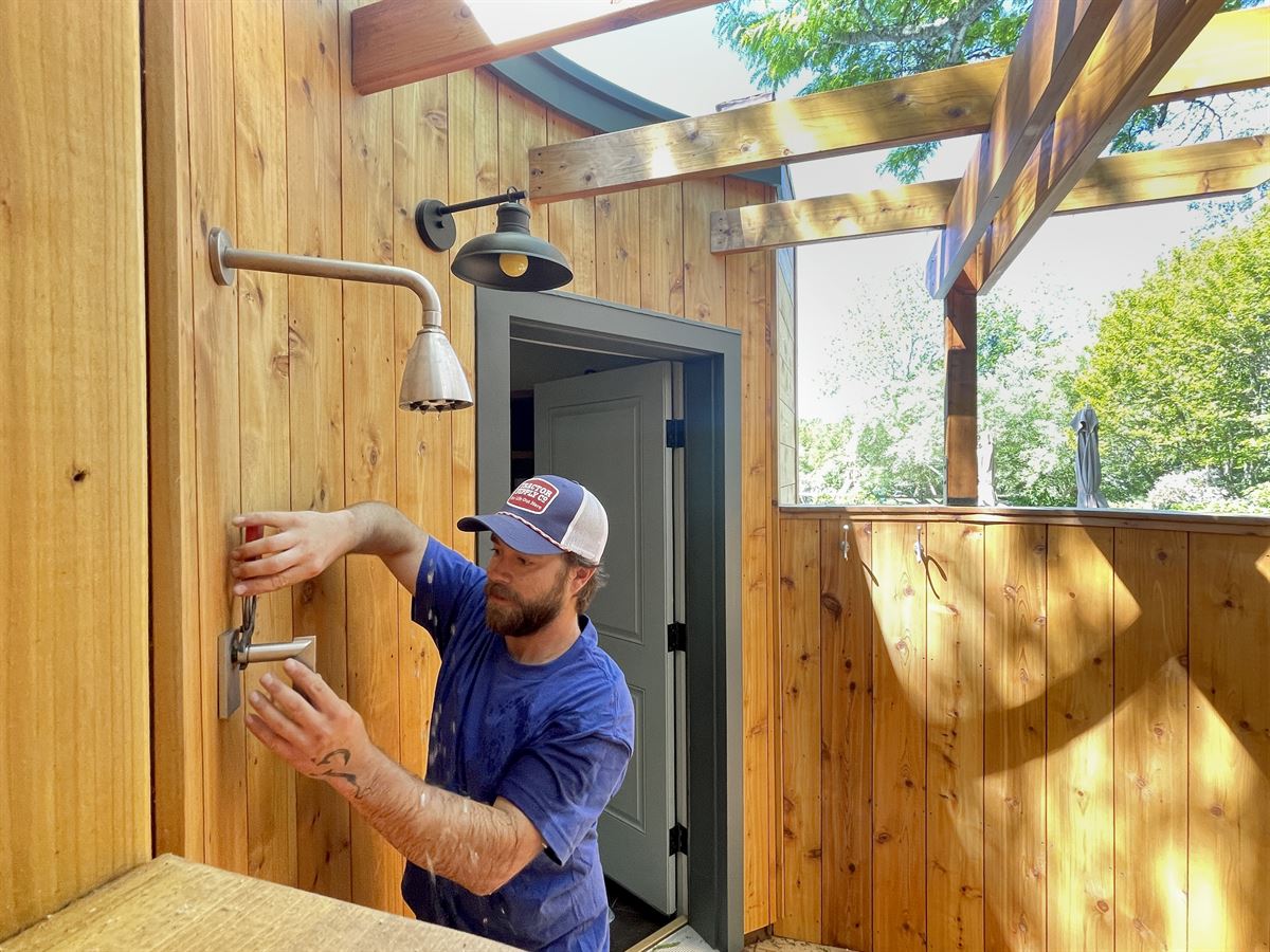 Technician repairing an outdoor shower valve