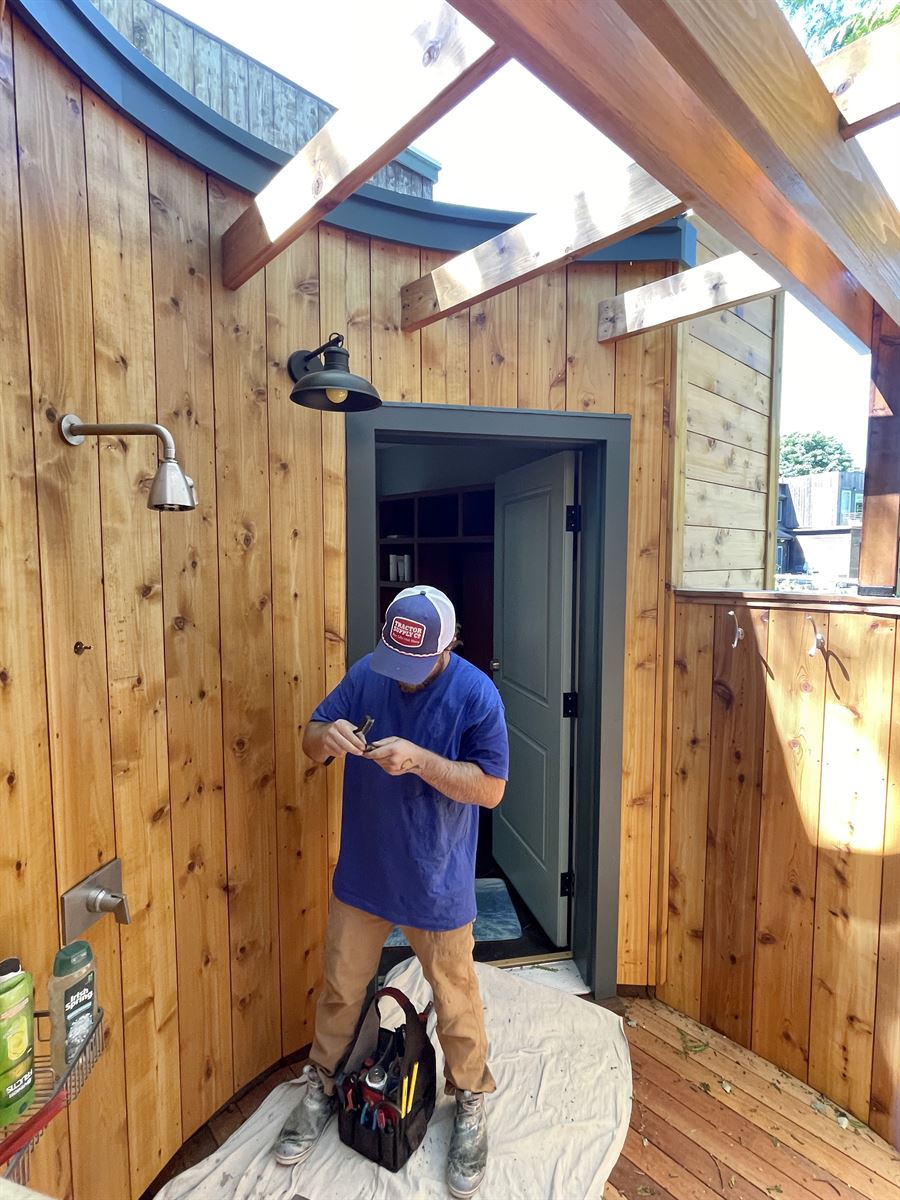 Technician repairing an outdoor shower valve